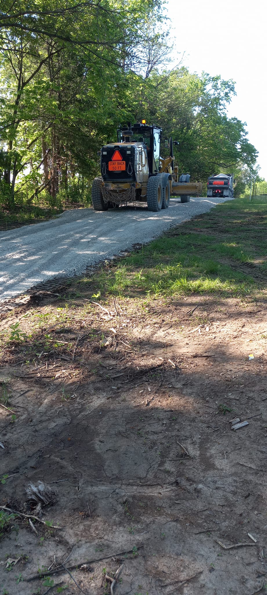Warren County Engineer and Bruening Rock Products, Inc at work putting gravel on 108th Avenue